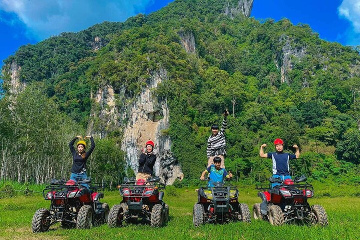 a group of people on atvs in front of a mountain
