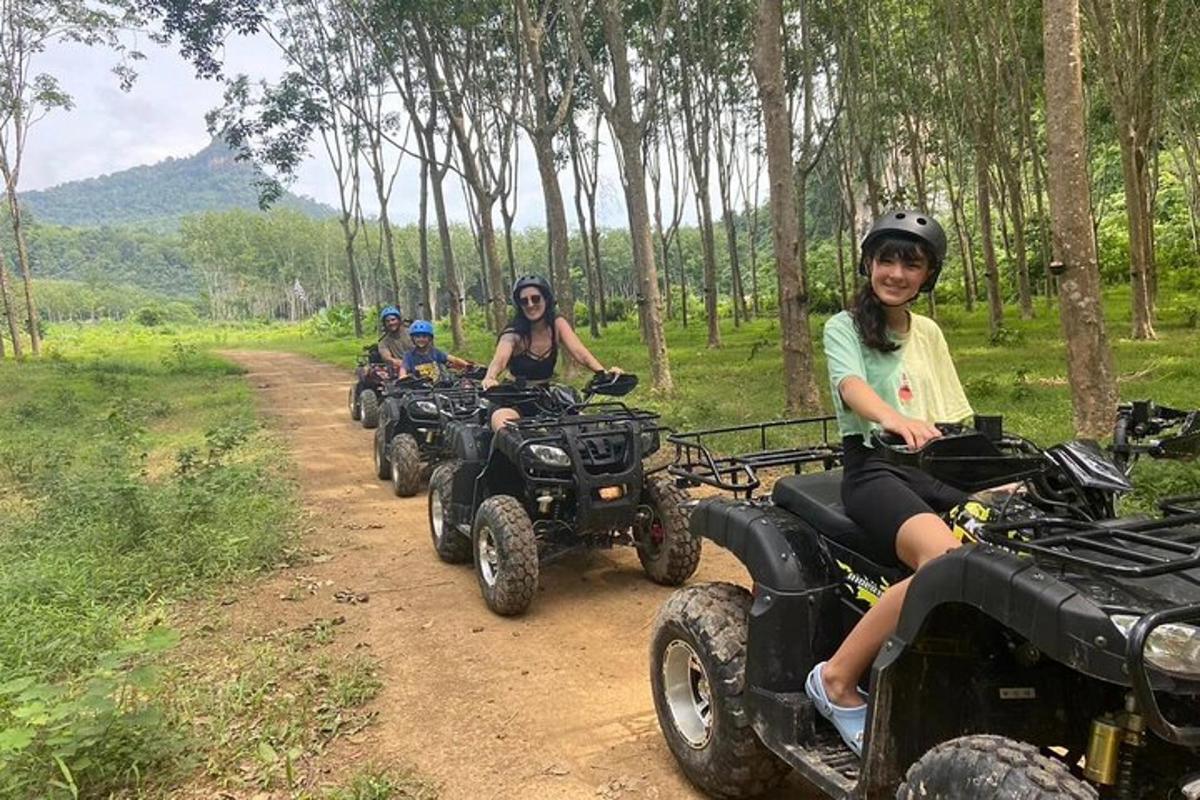 a group of people riding atvs on a dirt road