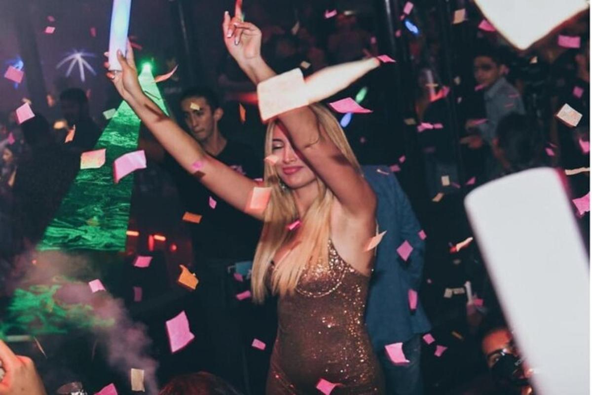 a young woman in a party throwing confetti