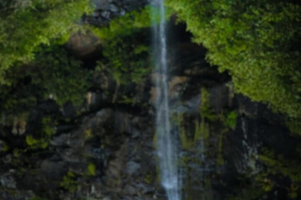 a waterfall in the middle of a river