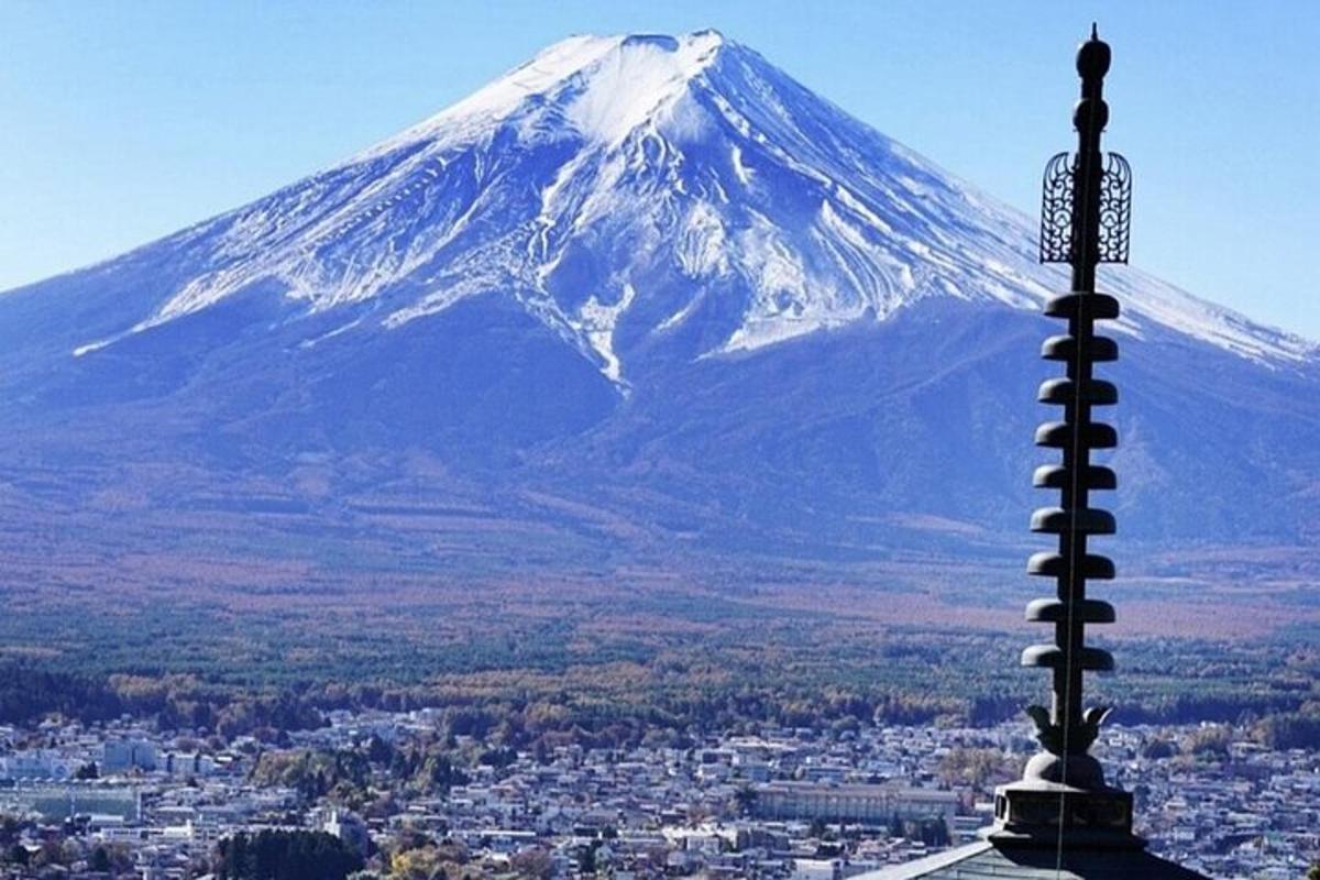 a snow covered mountain in the background with a pole