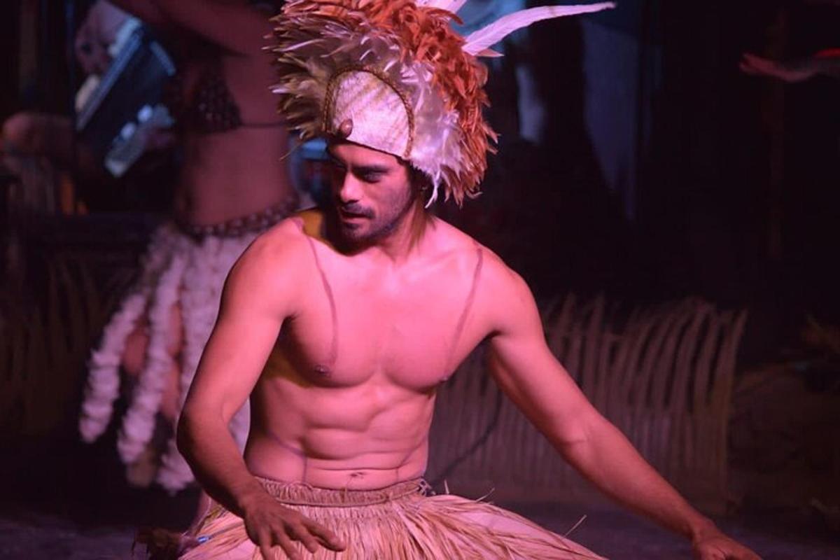 a man with no shirt on standing on a stage