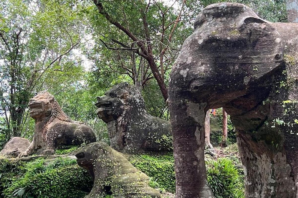 a group of statues of lions sitting next to trees