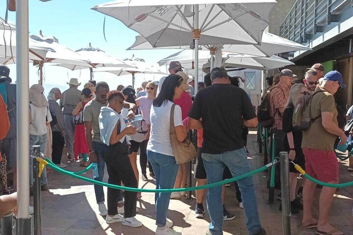 hópur fólks stendur undir hvítum regnhlífum