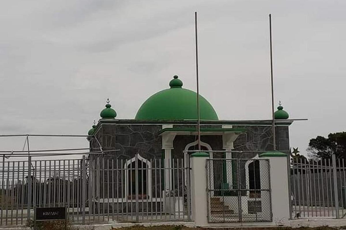a building with a green dome on top of a fence