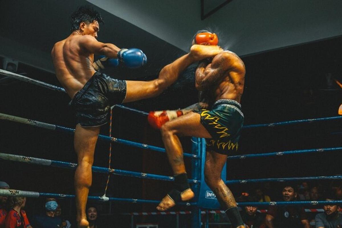 two men are fighting in a boxing match