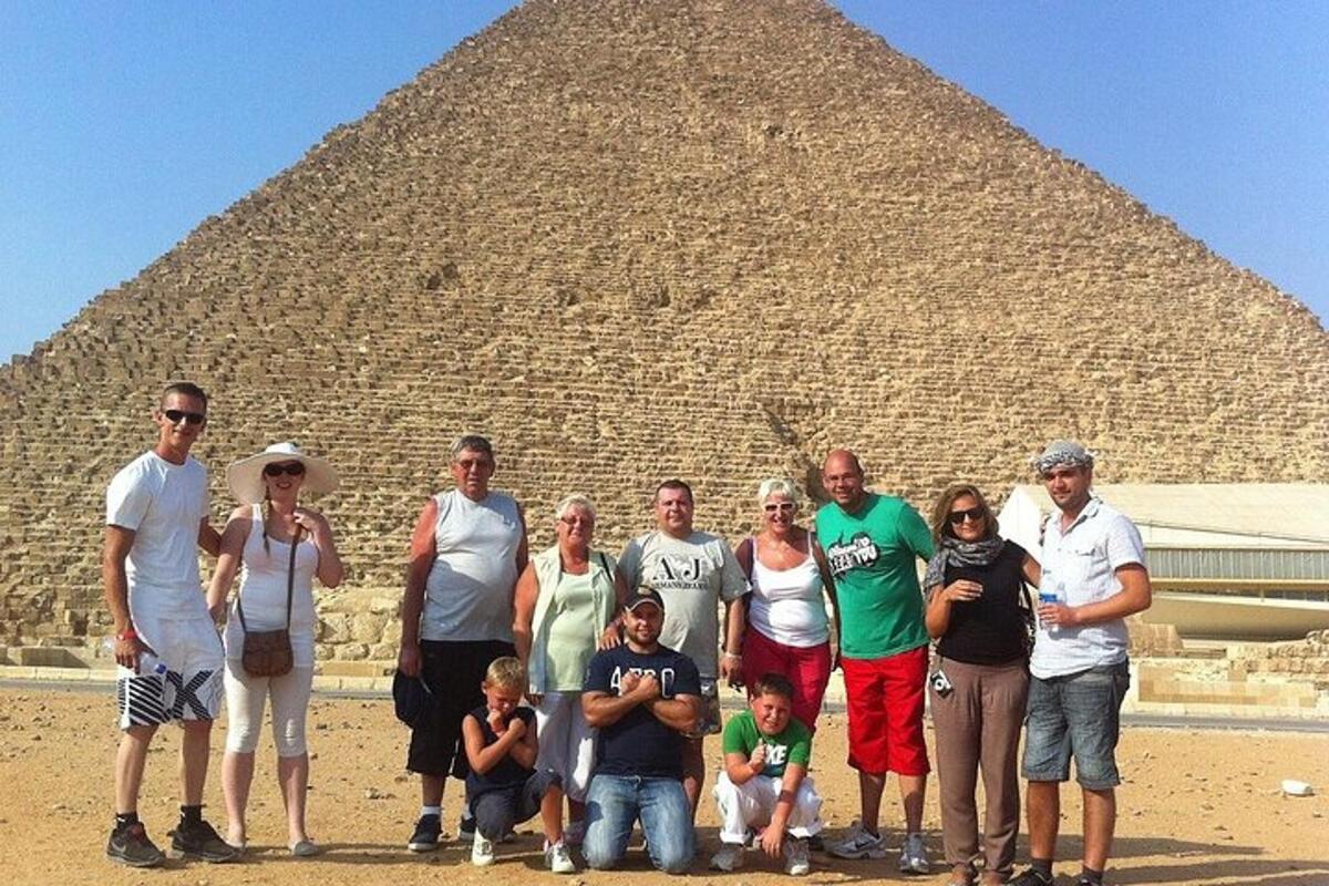 a group of people standing in front of a pyramid
