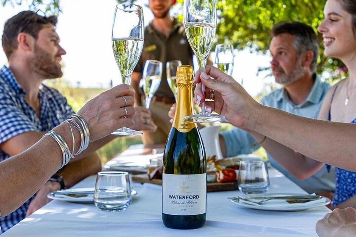 Un grupo de personas sentadas en una mesa con copas de vino.