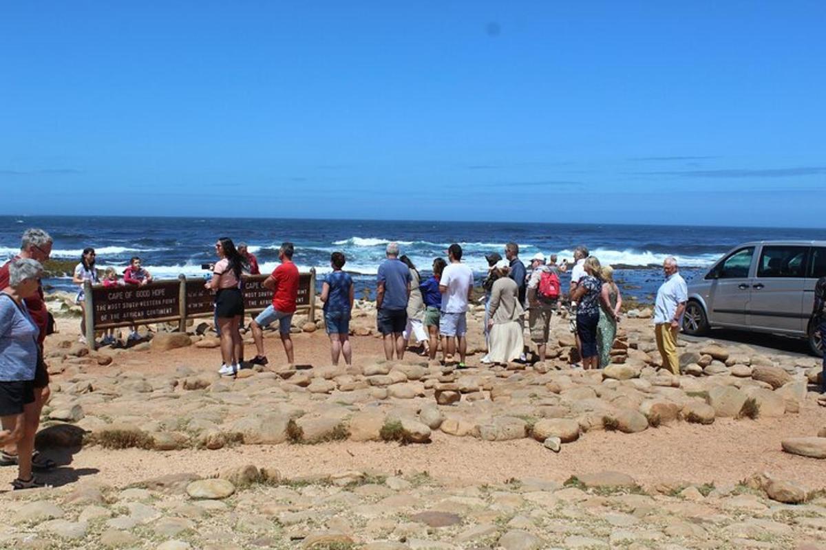 a group of people standing on the beach