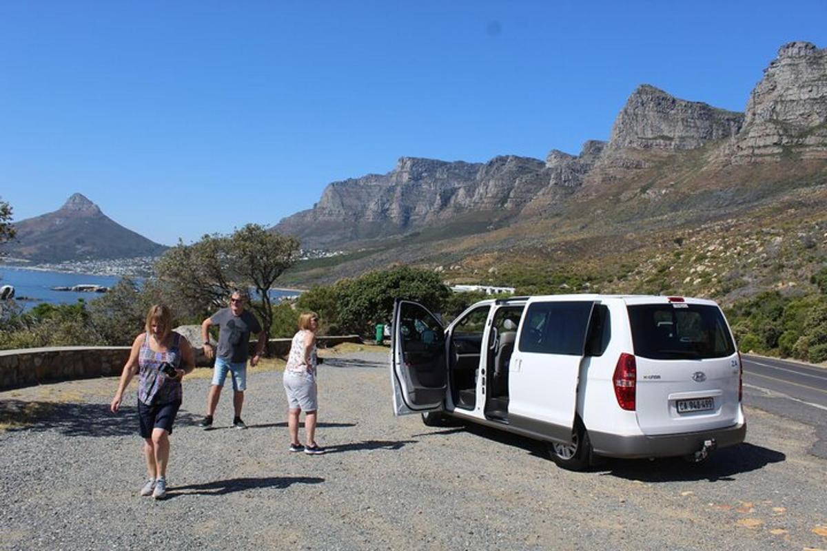 a group of people standing next to a van with its door open