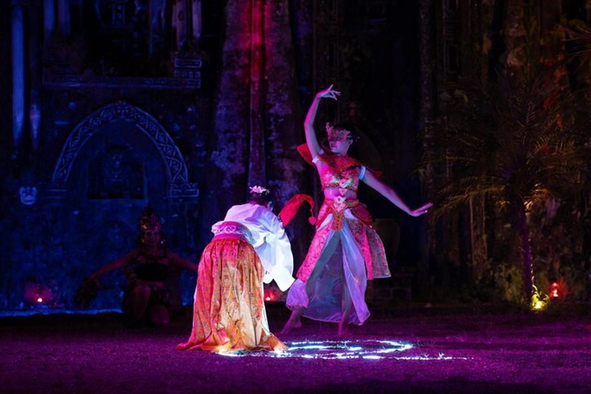 two women in dresses are dancing on a stage