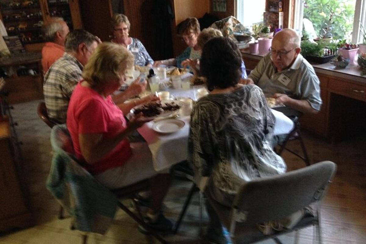 a group of people sitting around a table eating