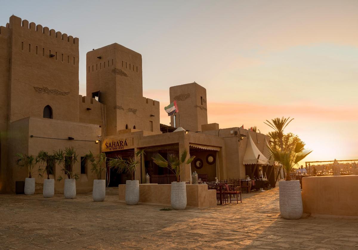 a building in the desert with a restaurant in front
