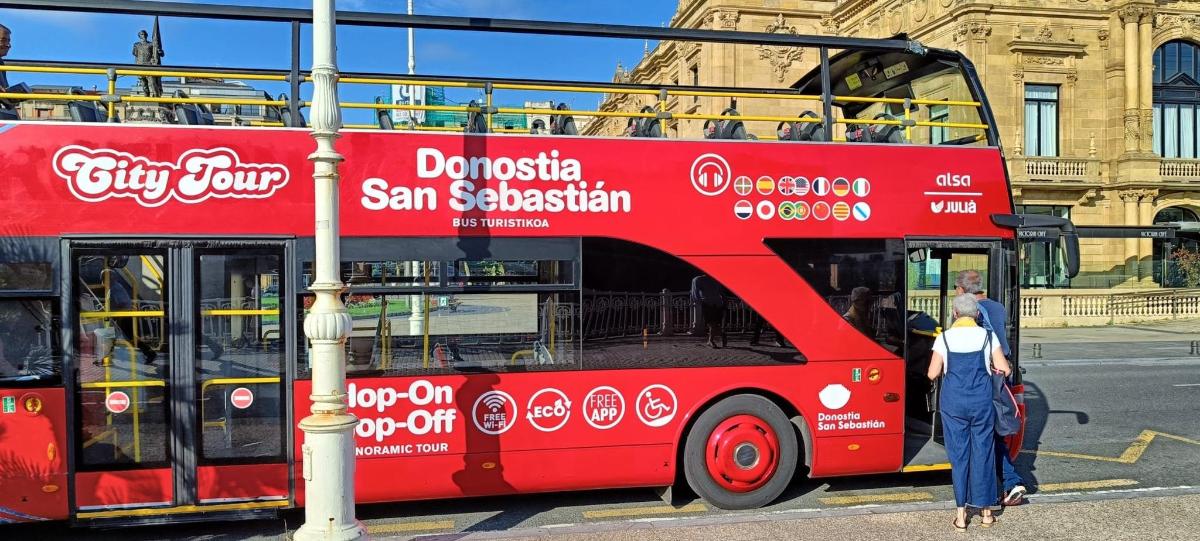 a red double decker bus parked on a street