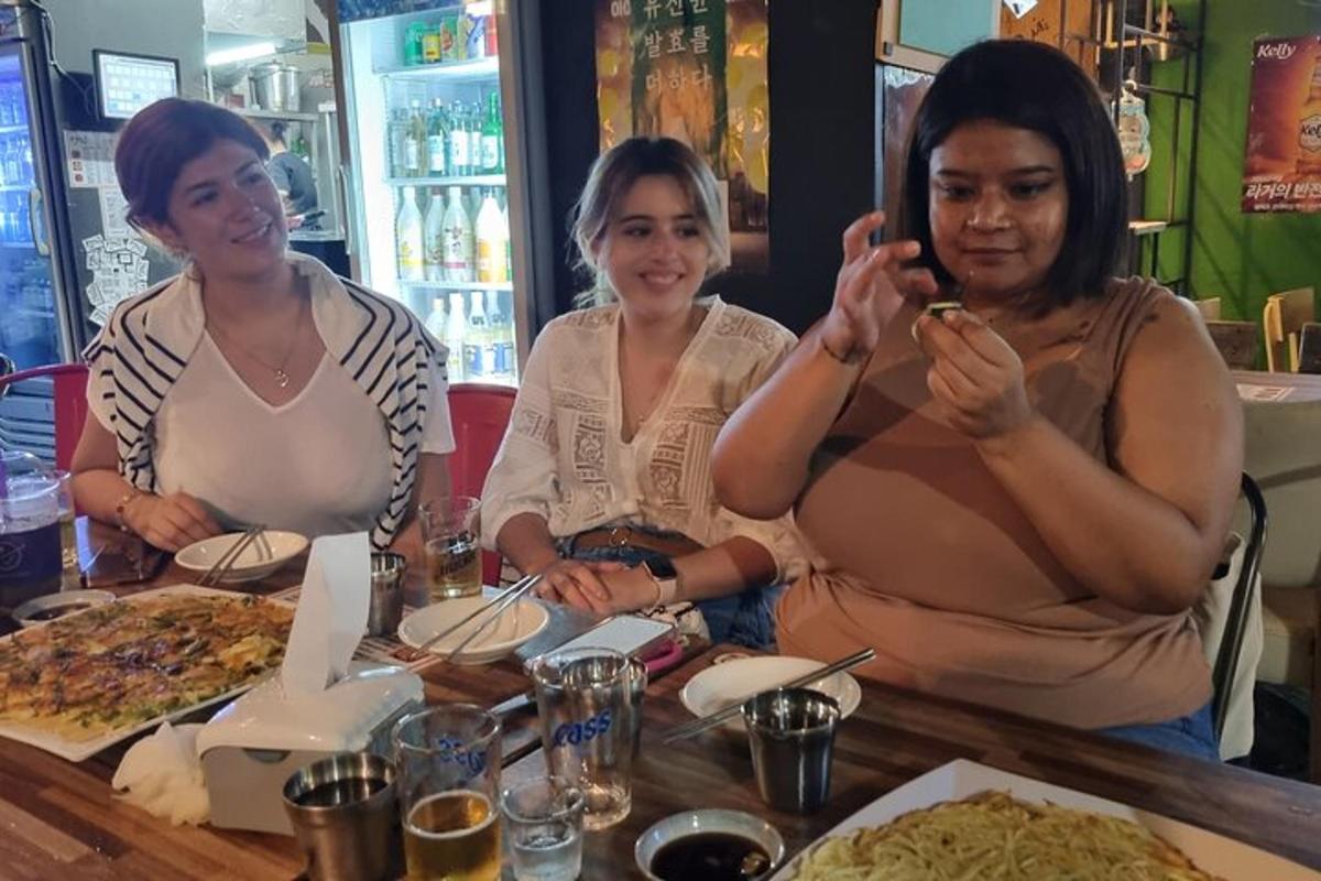 a group of three women sitting at a table