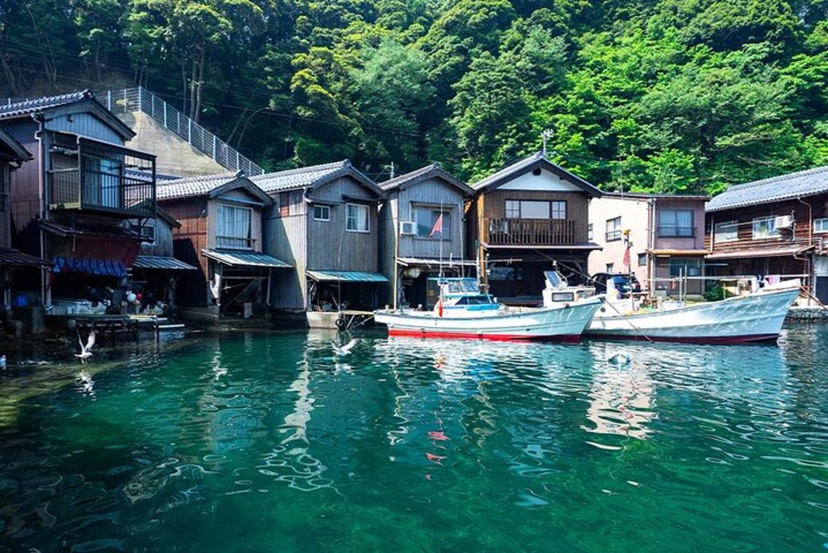two boats in a body of water next to houses