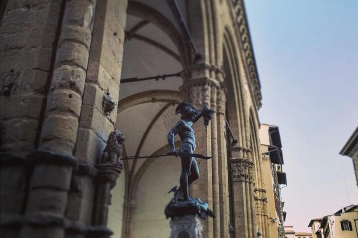 a statue of a woman hanging from the side of a building