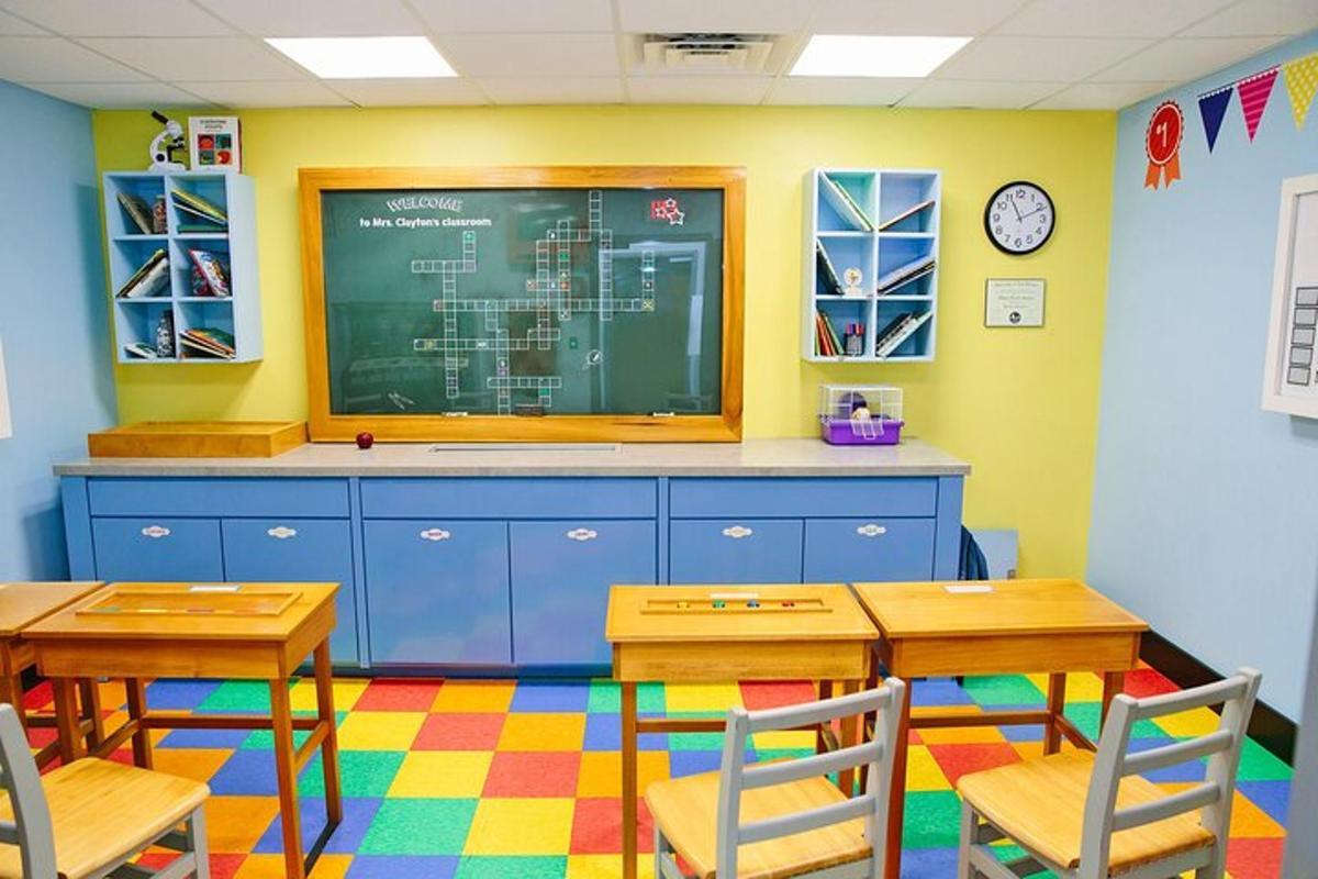 a classroom with two tables and a chalk board