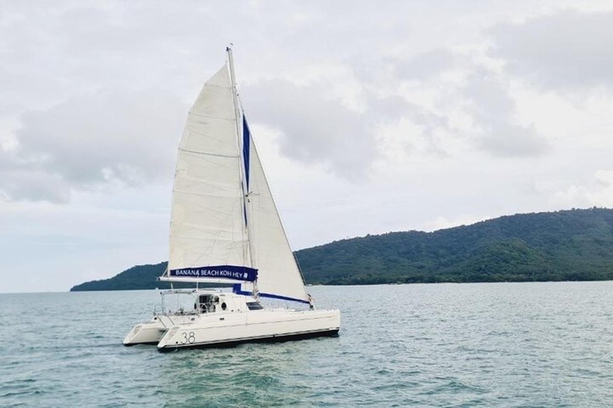a white sail boat floating on the water