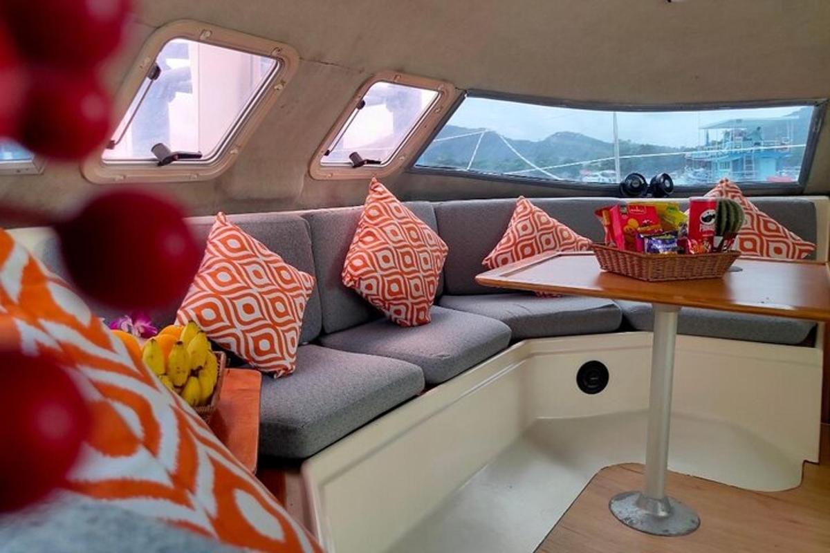 a couch with pillows on it with a table