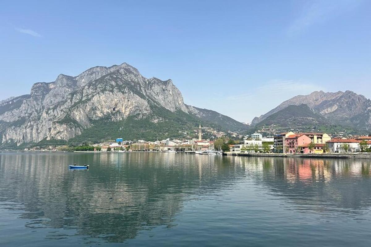 a small boat in a body of water with mountains