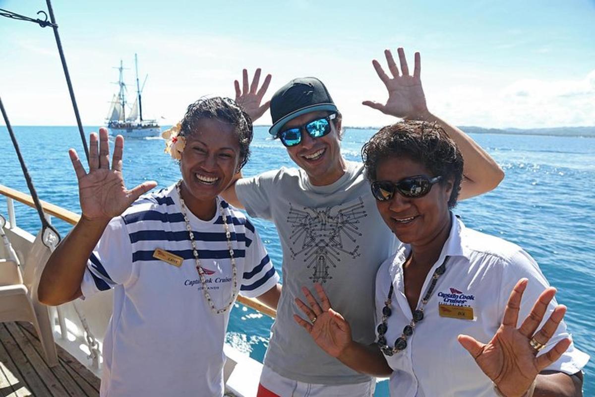 three people posing for a picture on a boat