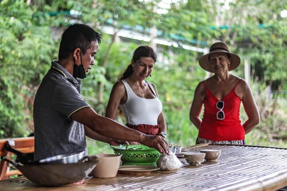 a man and two women standing around a table