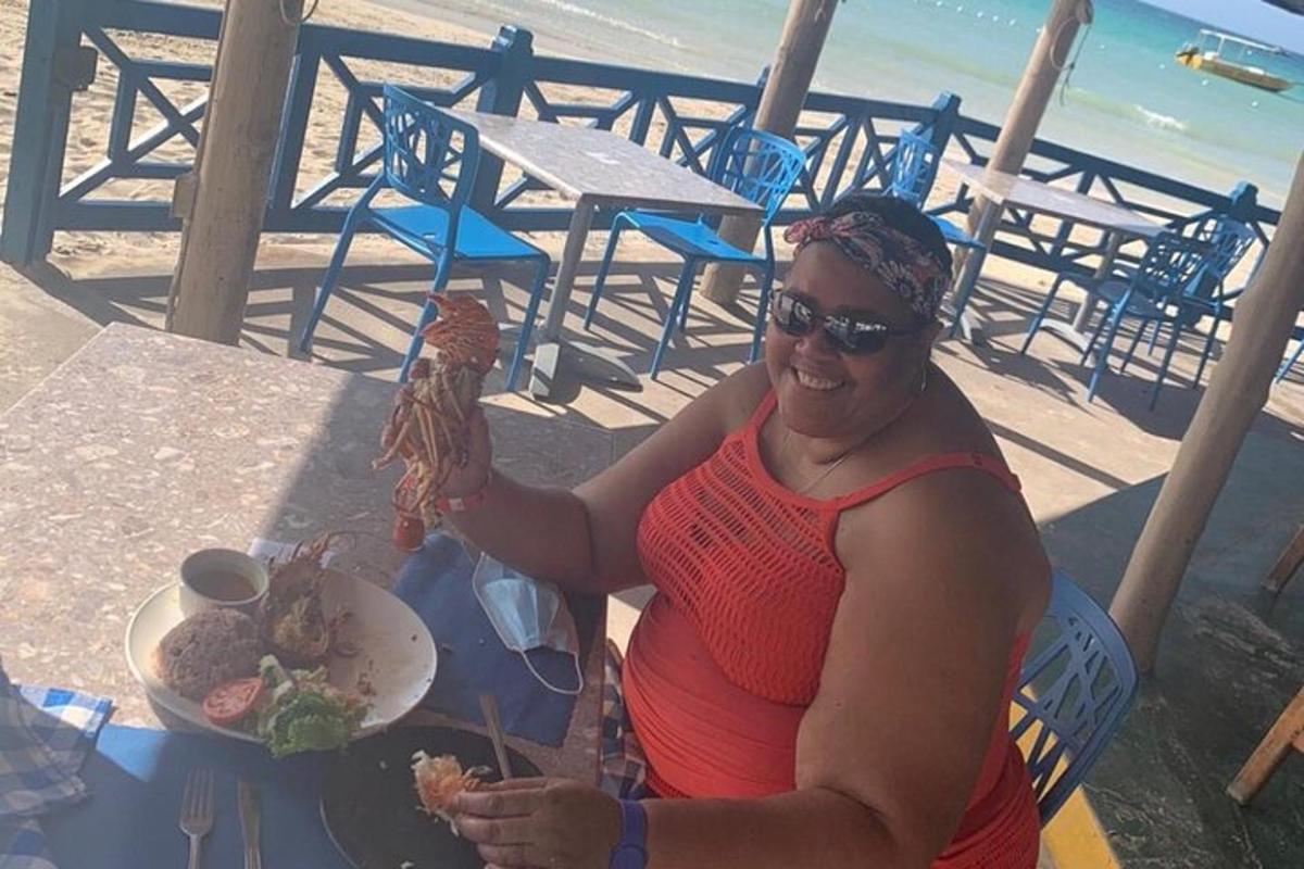 a woman sitting at a table with a plate of food