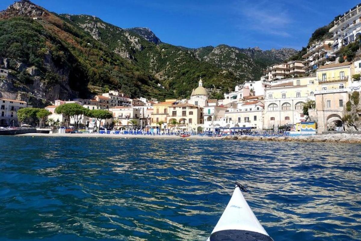 a boat in the water in front of a city