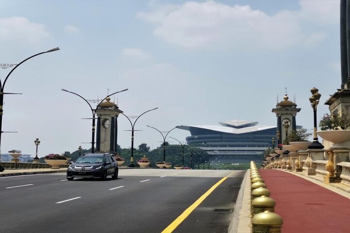 a car driving down a road with a building
