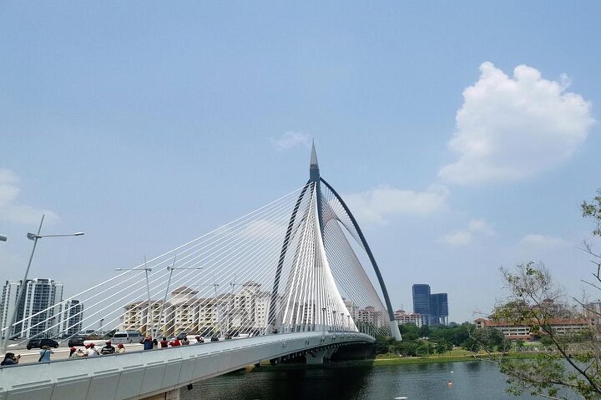 a white bridge over a river with cars on it