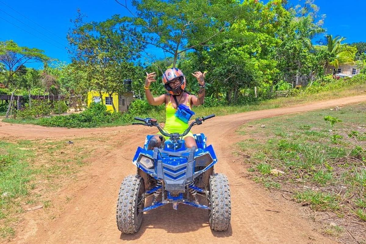 a woman riding a quad bike on a dirt road