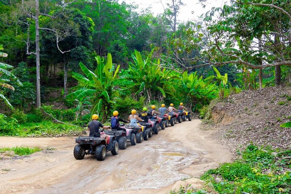 um grupo de pessoas andando de quadriciclo em uma estrada de terra