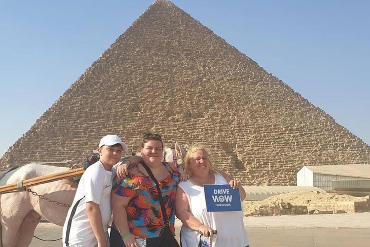 skupina lidí stojící před pyramidou