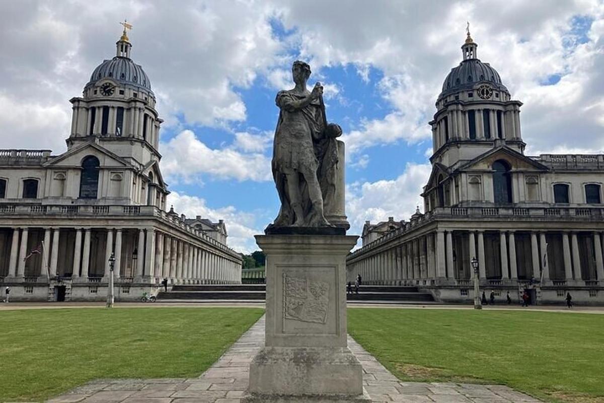 a statue in front of a building with two towers