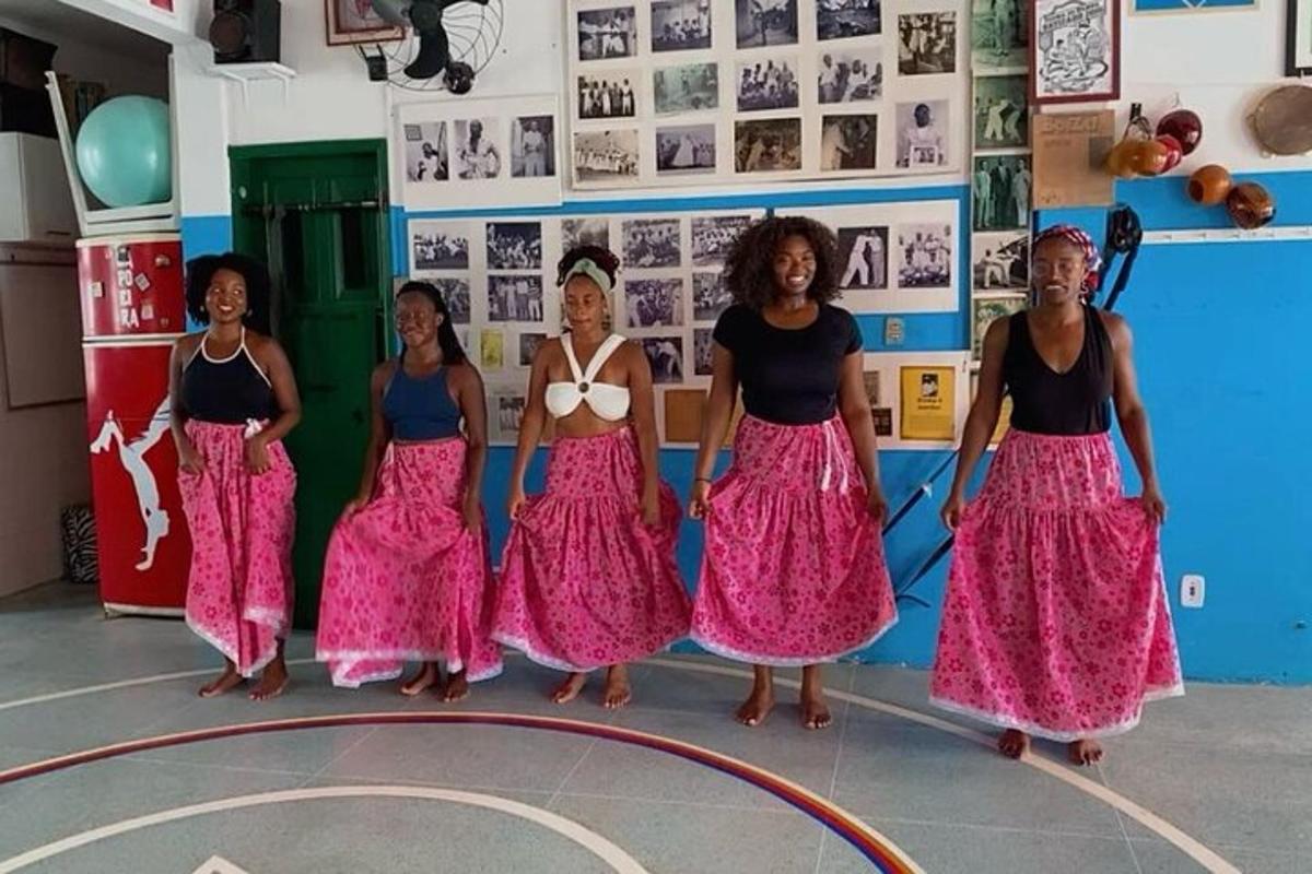 a group of women in skirts standing in a gym