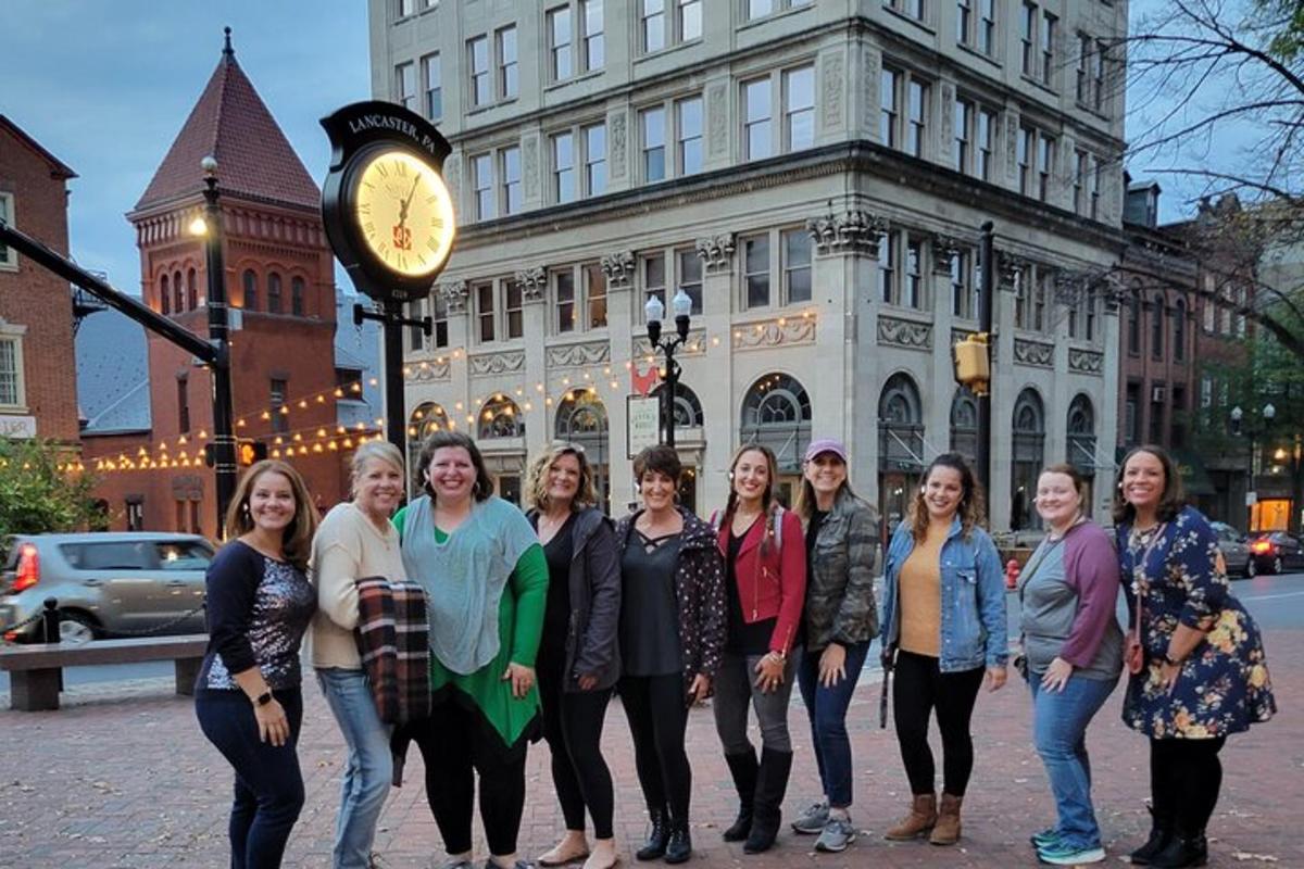 a group of women standing in front of a clock