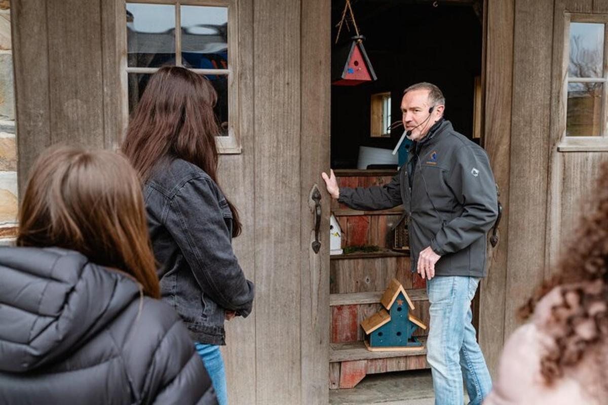 a man standing in a doorway talking to a group of people