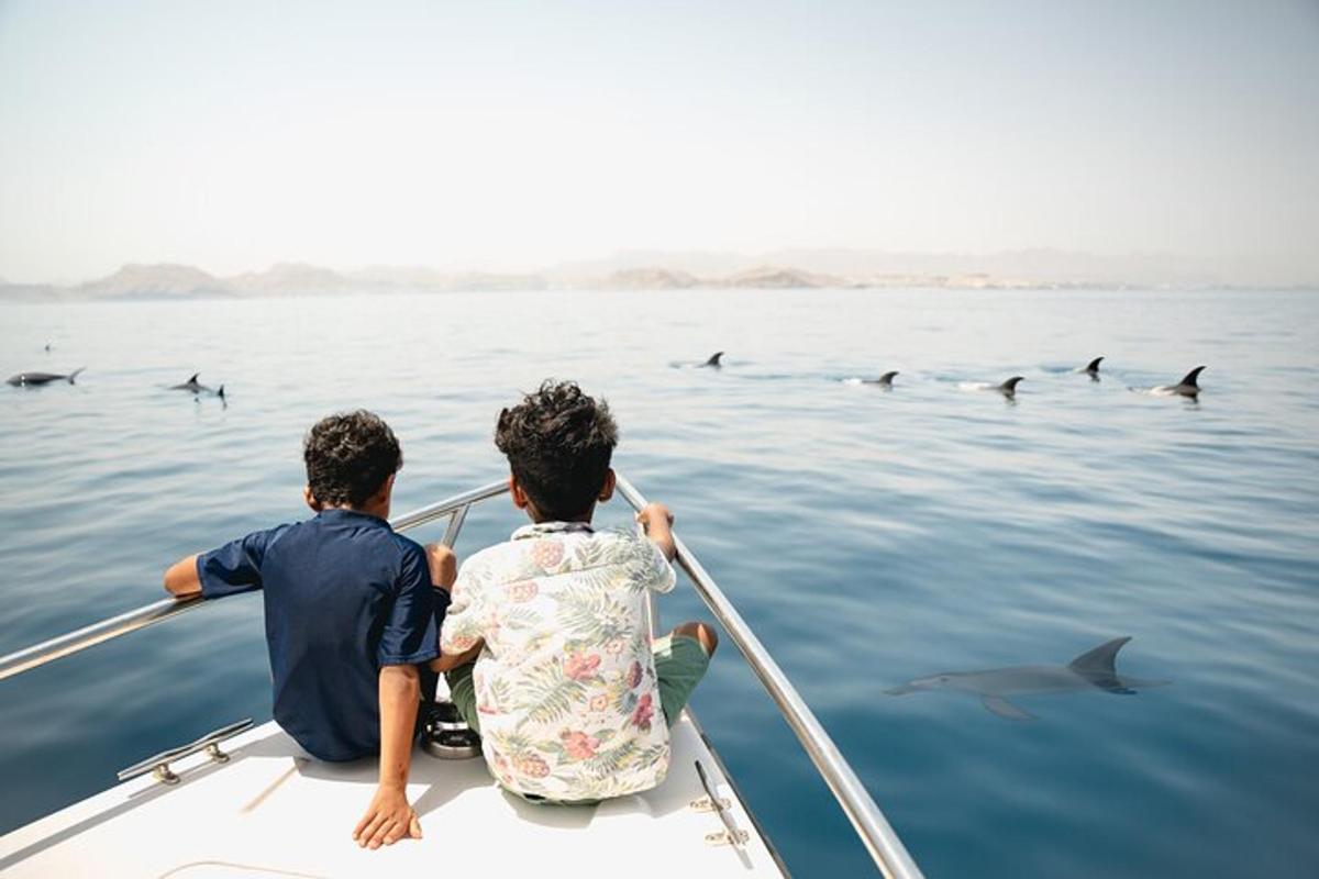 two boys in a boat with sharks in the water