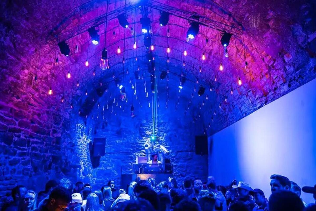 a crowd of people in a room with purple lights