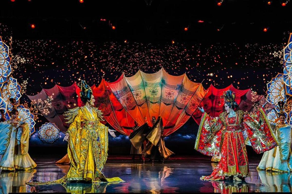 a group of people on a stage with umbrellas