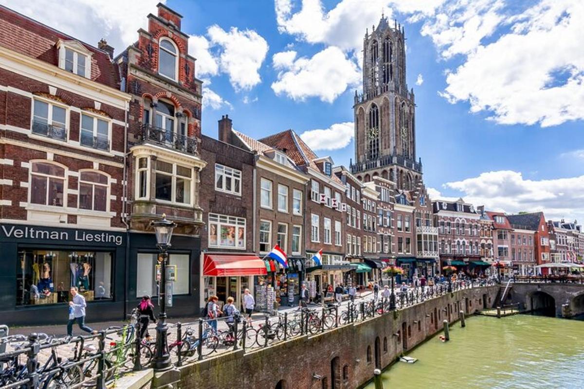 a canal in a city with buildings and a clock tower