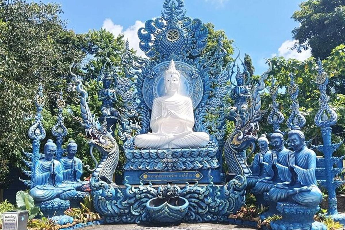 a large blue and white statue in a park