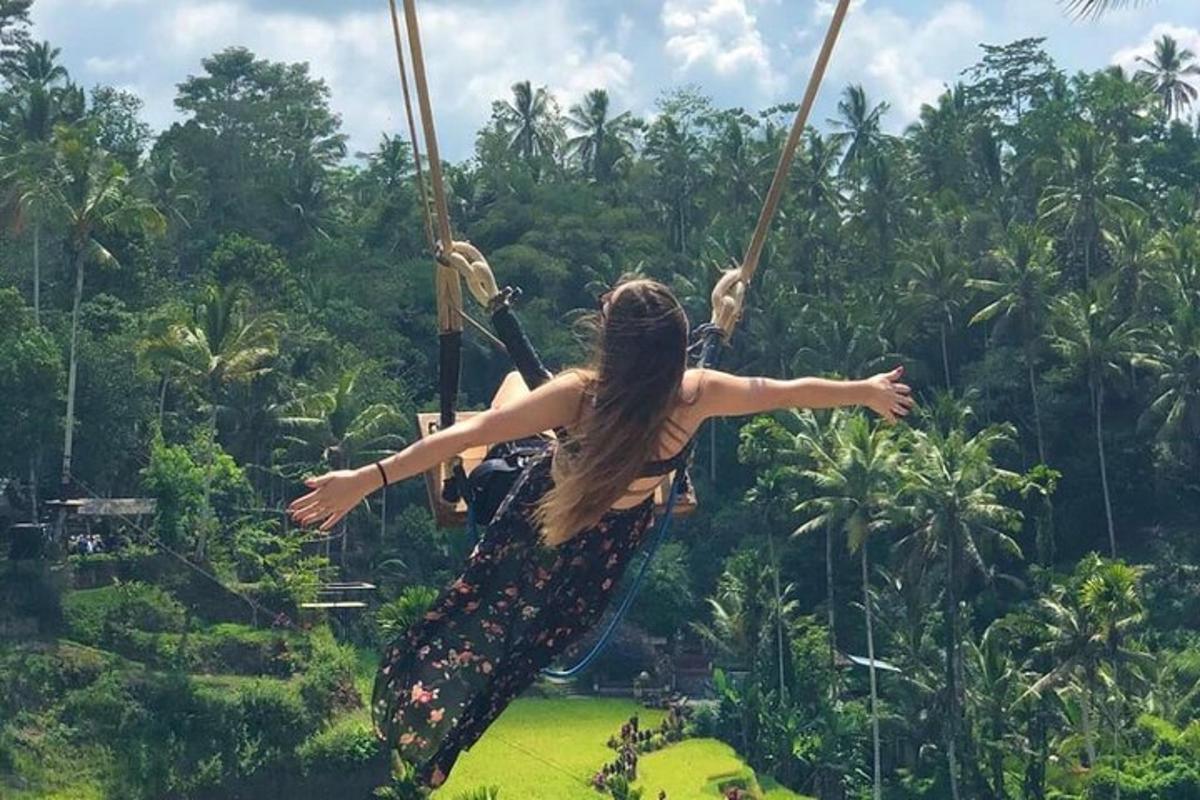 a woman swinging on a rope swing