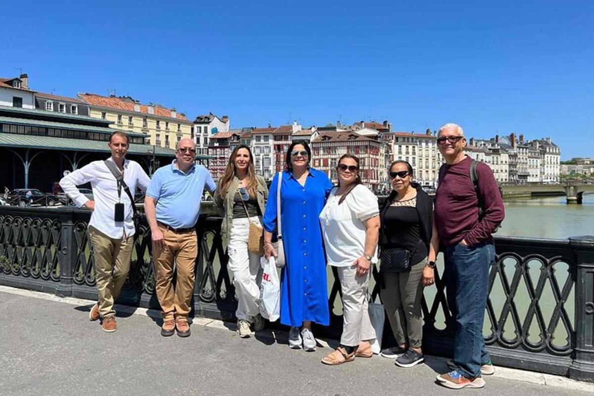a group of people posing for a picture on a bridge
