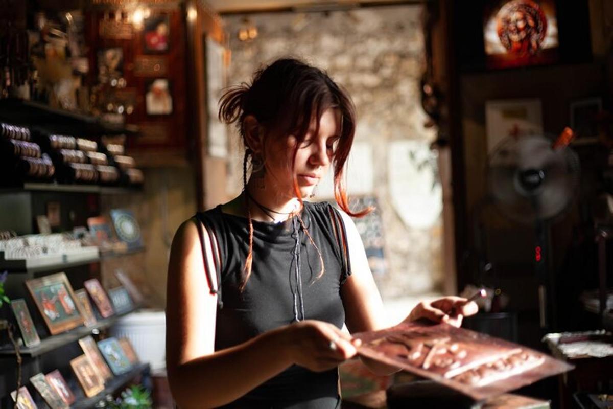 a woman standing in a store holding a plate of food