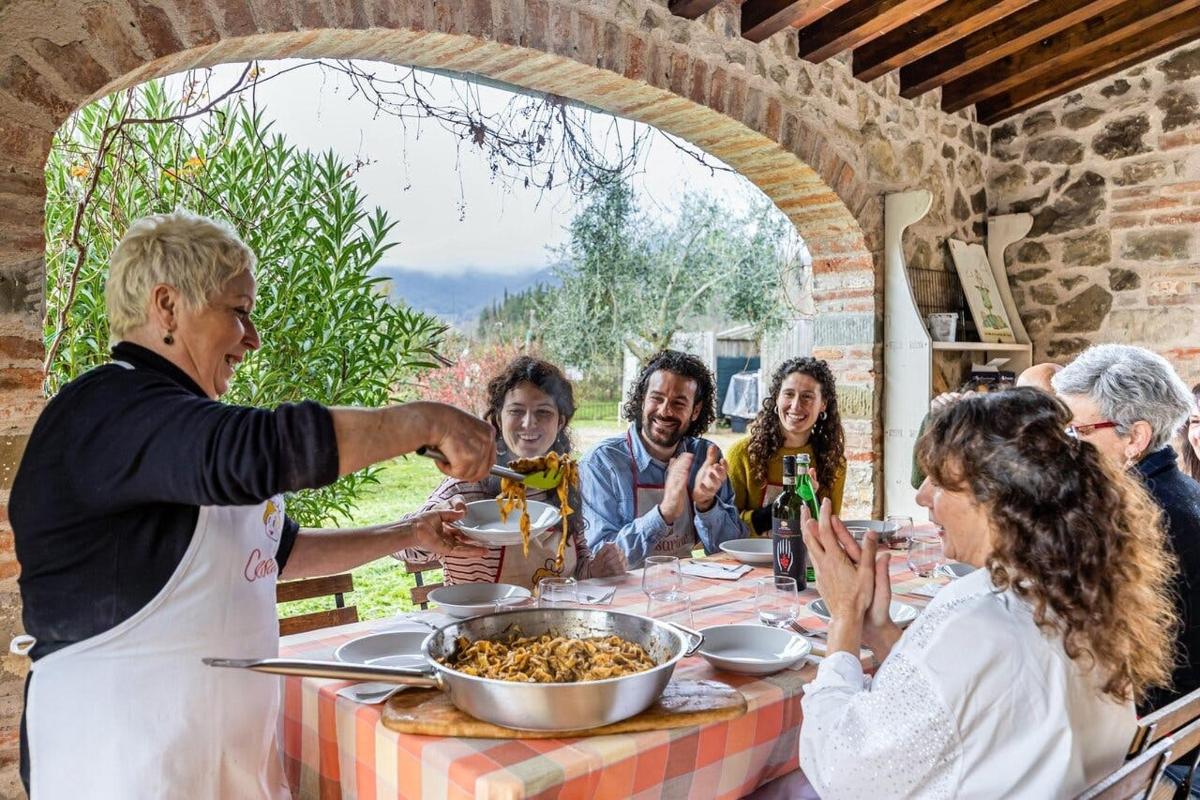 a group of people sitting around a table eating food