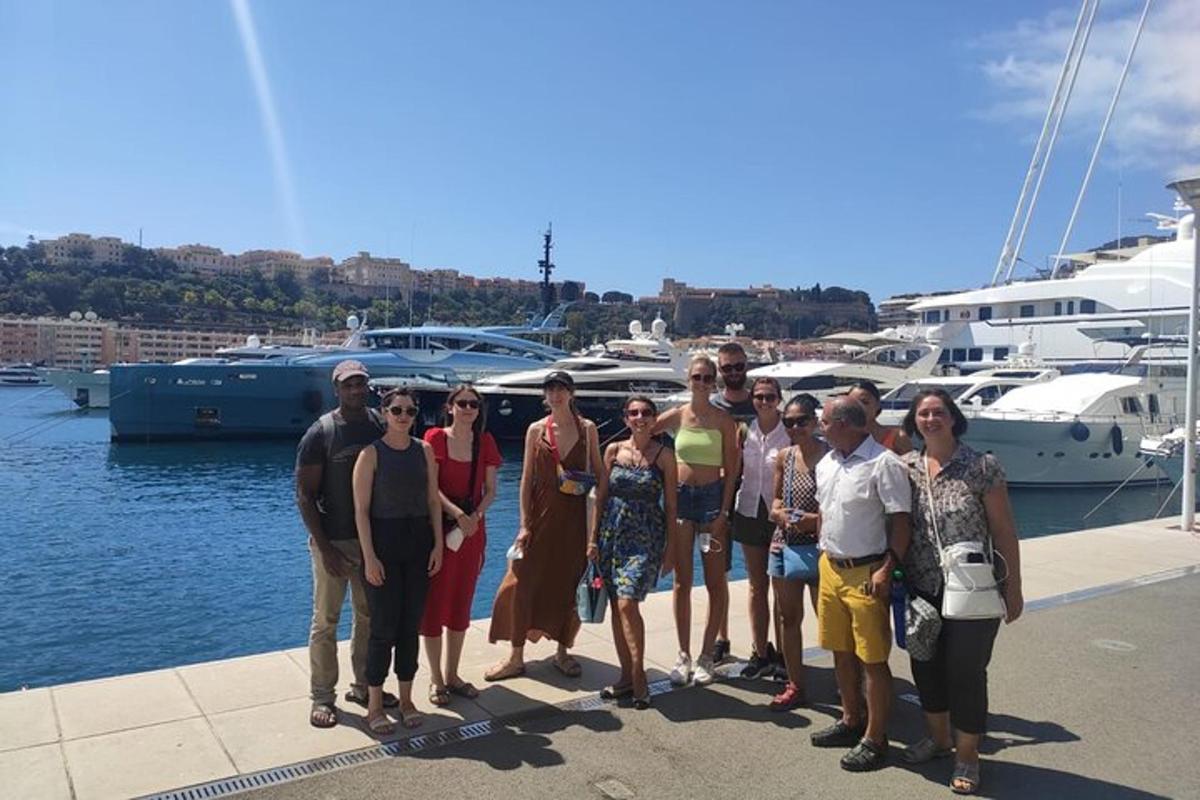 a group of people posing for a picture at a marina
