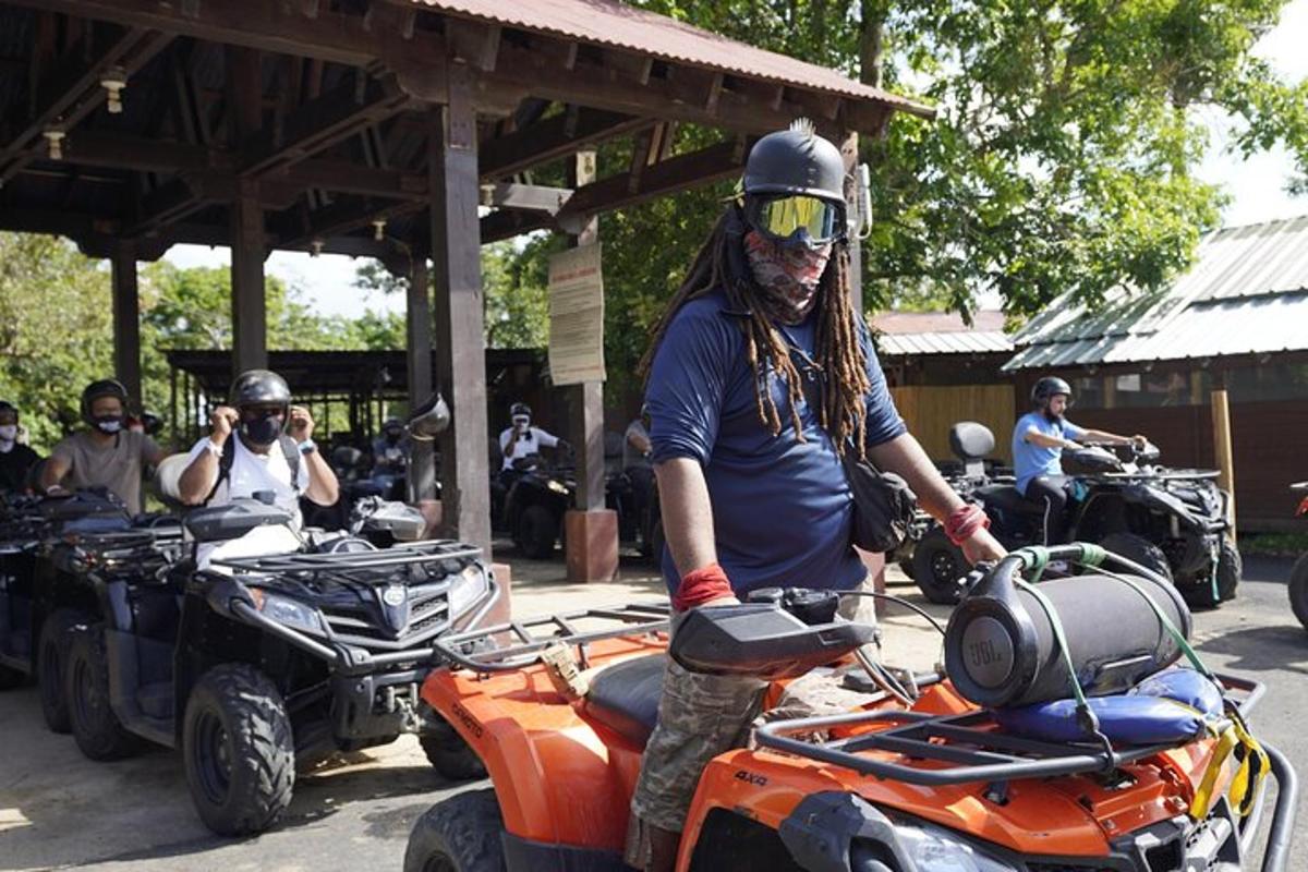 a man wearing a helmet on top of an atv