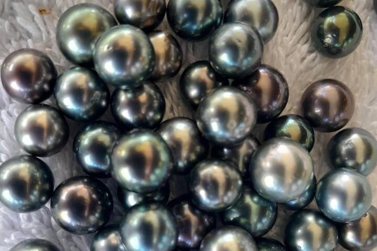 a pile of silver balls on a plate